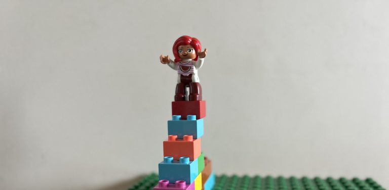 A Lego figurine standing on Lego steps, illustrating the lessons I learned in growing my RRSP.